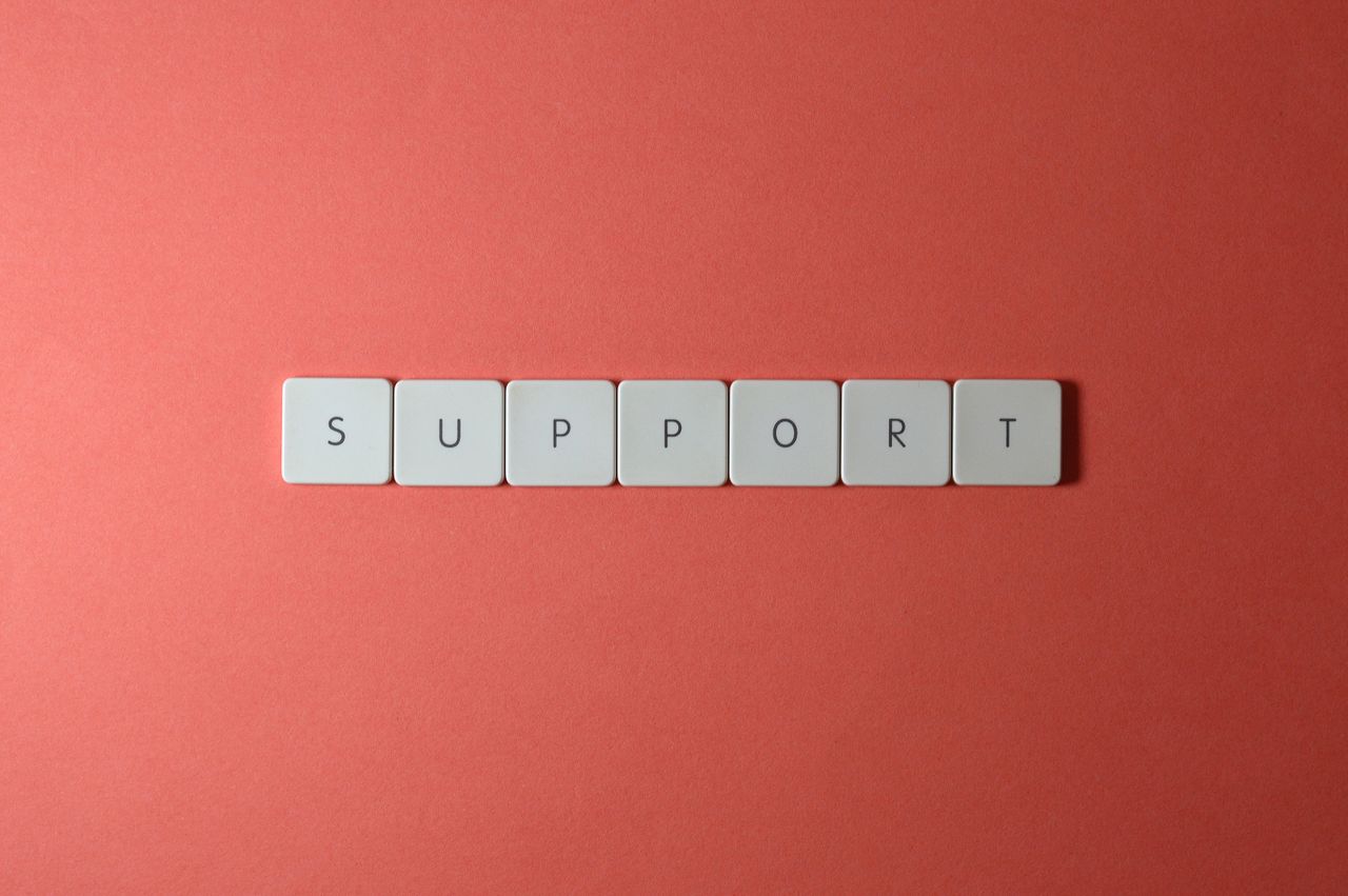 ours-journey Close-up of the word 'support' spelled with keyboard keys on a red background.